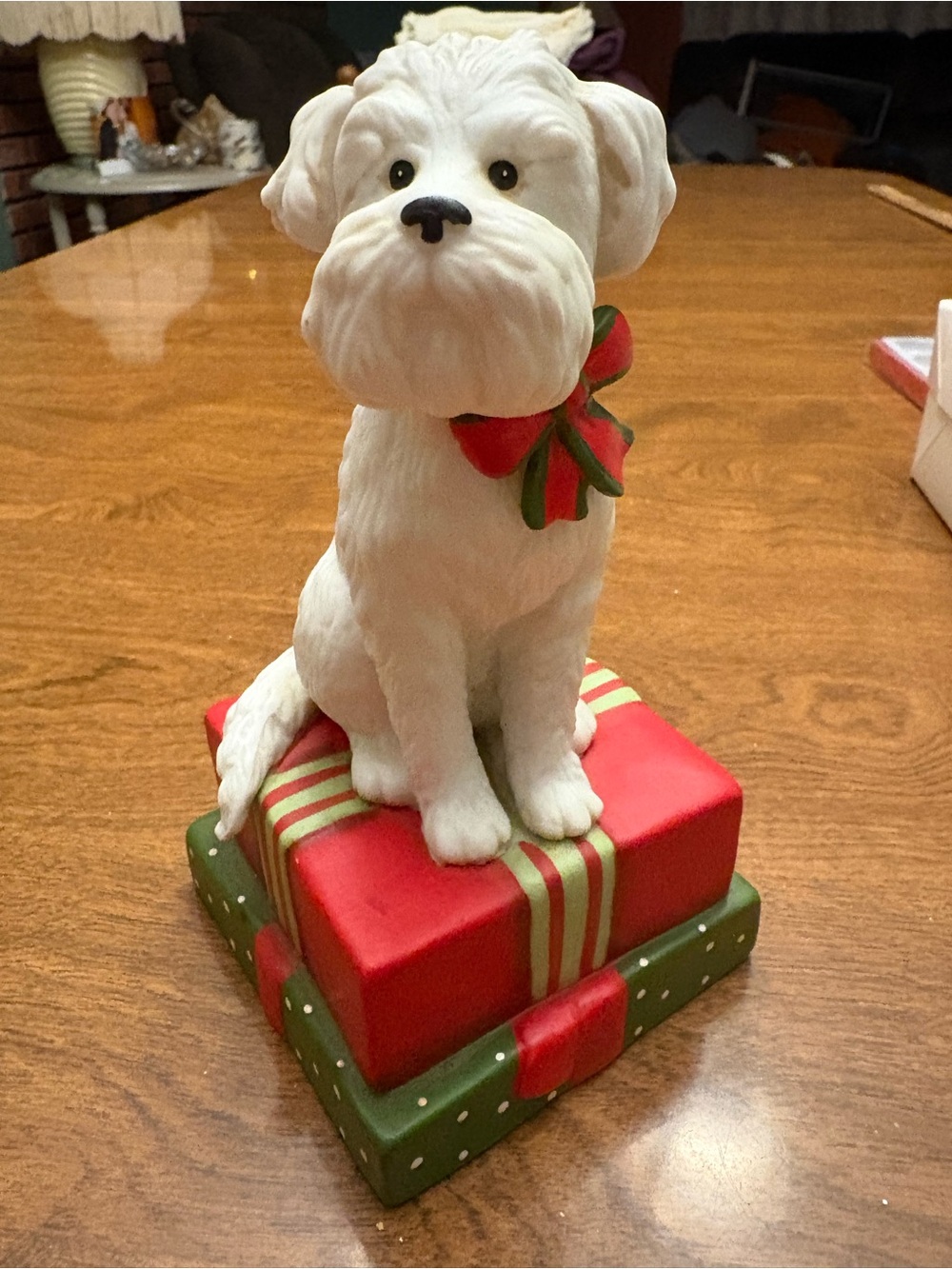 White Holiday Dog Figurine with Red & Green Bow on Festive Gift Base